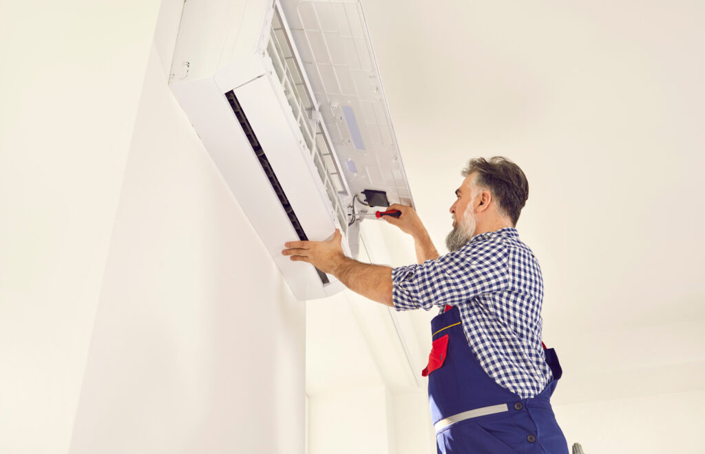 A Man Doing AC Service